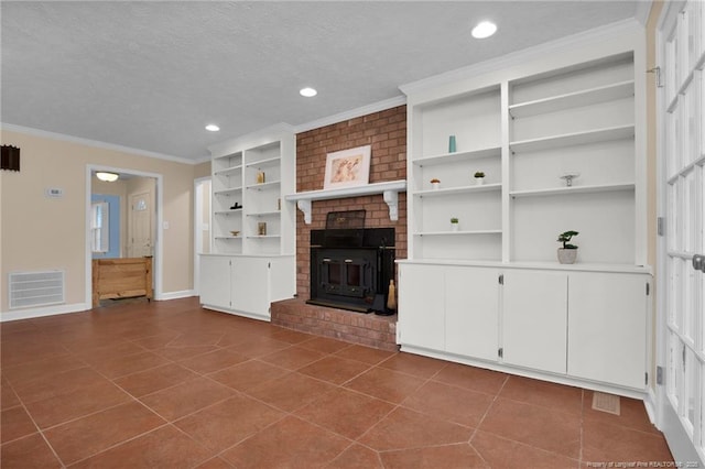 unfurnished living room with crown molding, visible vents, a textured ceiling, dark tile patterned flooring, and baseboards