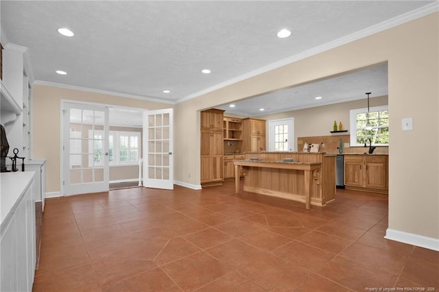 kitchen featuring a center island, open shelves, ornamental molding, dishwasher, and a kitchen breakfast bar