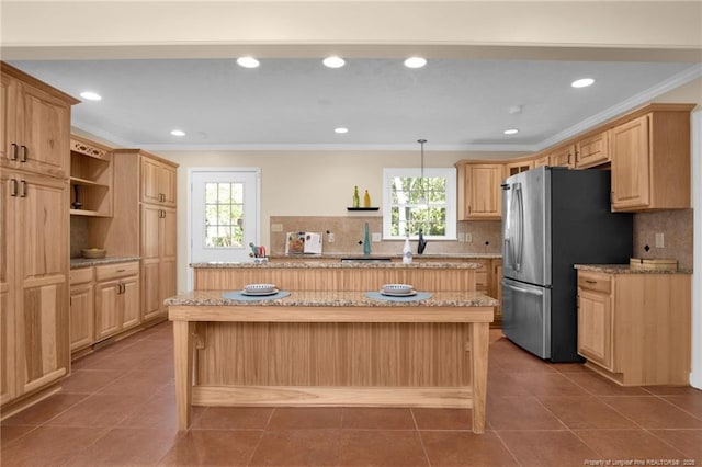 kitchen featuring dark tile patterned floors, a kitchen island, open shelves, and freestanding refrigerator