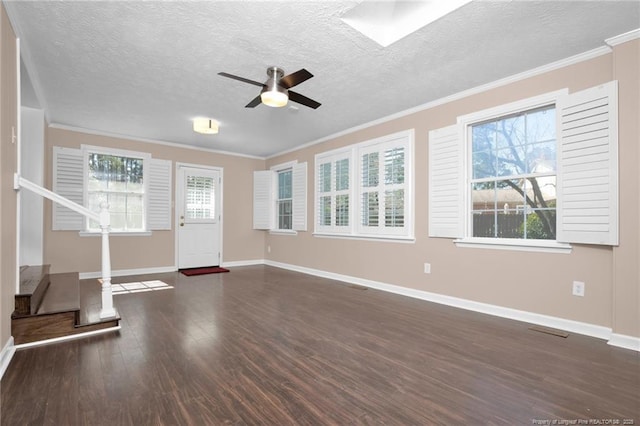 entryway featuring baseboards, ceiling fan, dark wood-type flooring, crown molding, and a textured ceiling