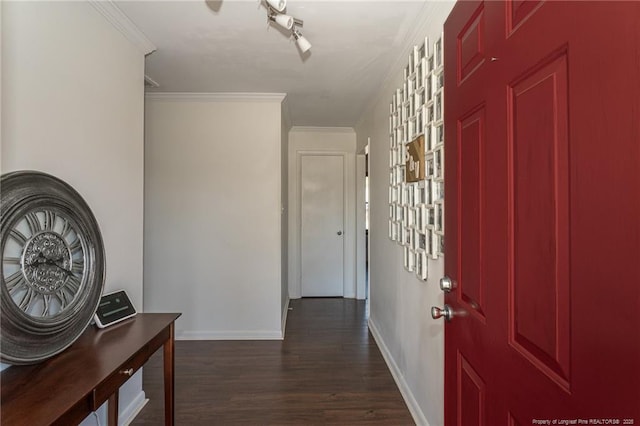 corridor featuring ornamental molding, dark wood-type flooring, and baseboards