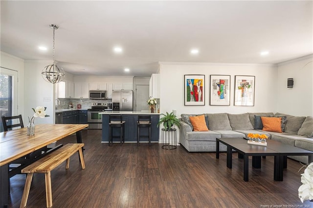 living area featuring ornamental molding, recessed lighting, and dark wood-style flooring