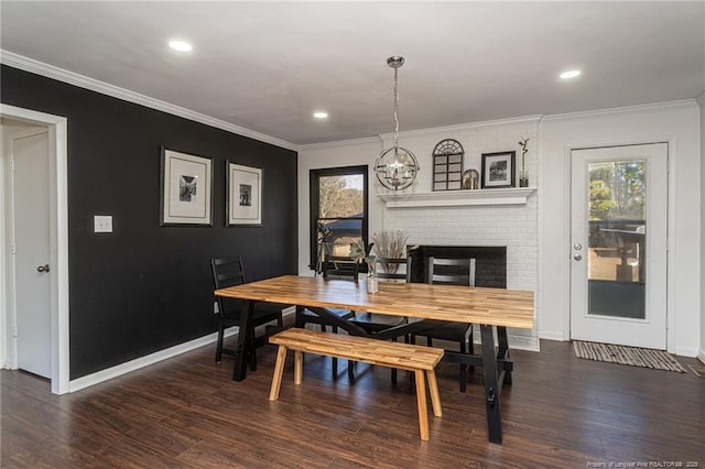 dining space with baseboards, wood finished floors, crown molding, a chandelier, and recessed lighting