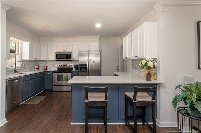 kitchen with a sink, white cabinetry, stainless steel appliances, and light countertops