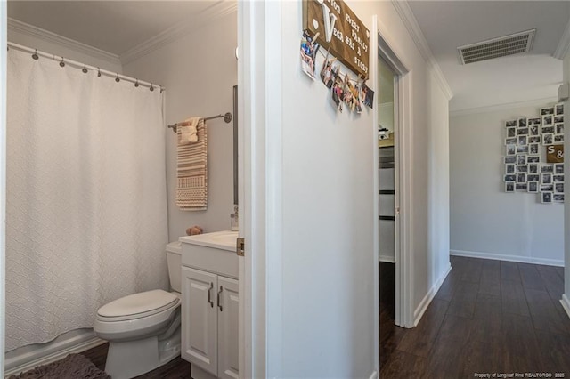 bathroom featuring toilet, wood finished floors, vanity, visible vents, and crown molding