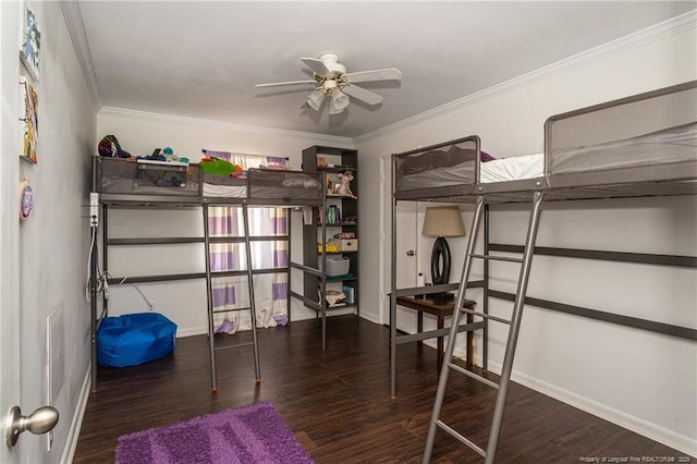 bedroom featuring crown molding, baseboards, and wood finished floors