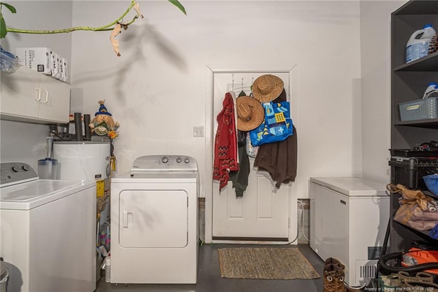 laundry room featuring independent washer and dryer and cabinet space