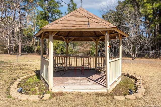 view of property's community featuring a fenced backyard, a deck, and a gazebo