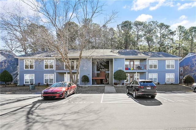 view of building exterior with uncovered parking