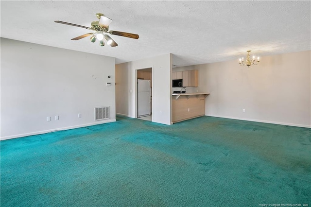 unfurnished living room featuring baseboards, visible vents, a textured ceiling, carpet floors, and ceiling fan with notable chandelier