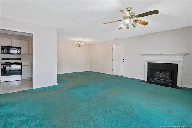 unfurnished living room with a textured ceiling, ceiling fan with notable chandelier, a fireplace with flush hearth, carpet flooring, and baseboards