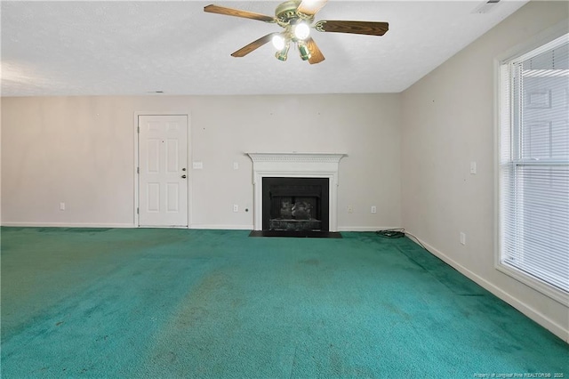 unfurnished living room featuring carpet floors, a fireplace with flush hearth, and baseboards