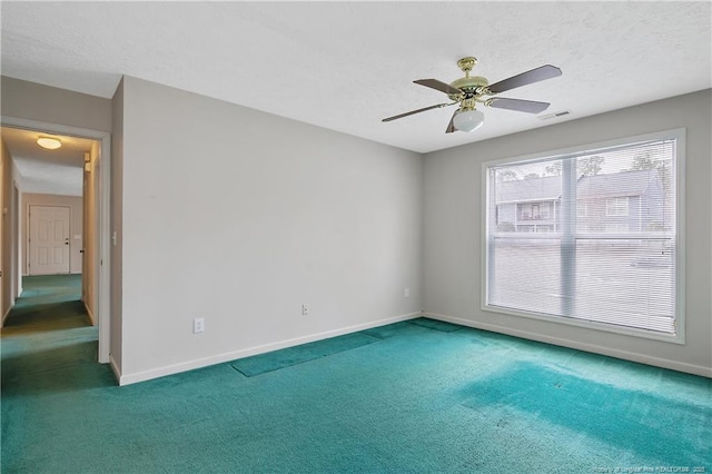 spare room with visible vents, carpet flooring, ceiling fan, a textured ceiling, and baseboards