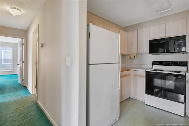 kitchen featuring electric range oven, freestanding refrigerator, light countertops, light brown cabinets, and black microwave