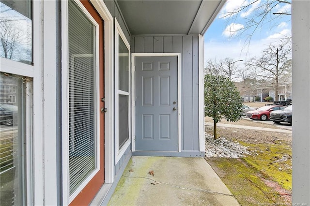 property entrance featuring board and batten siding