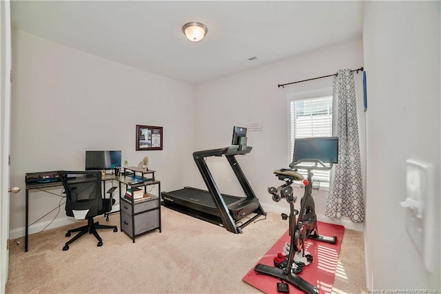 carpeted home office featuring visible vents and baseboards