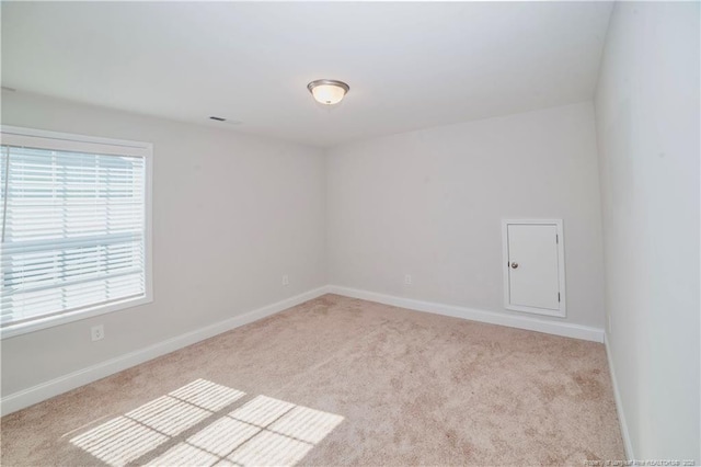 empty room with carpet floors and baseboards