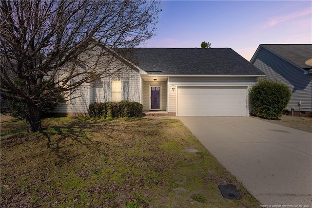 single story home featuring concrete driveway and an attached garage