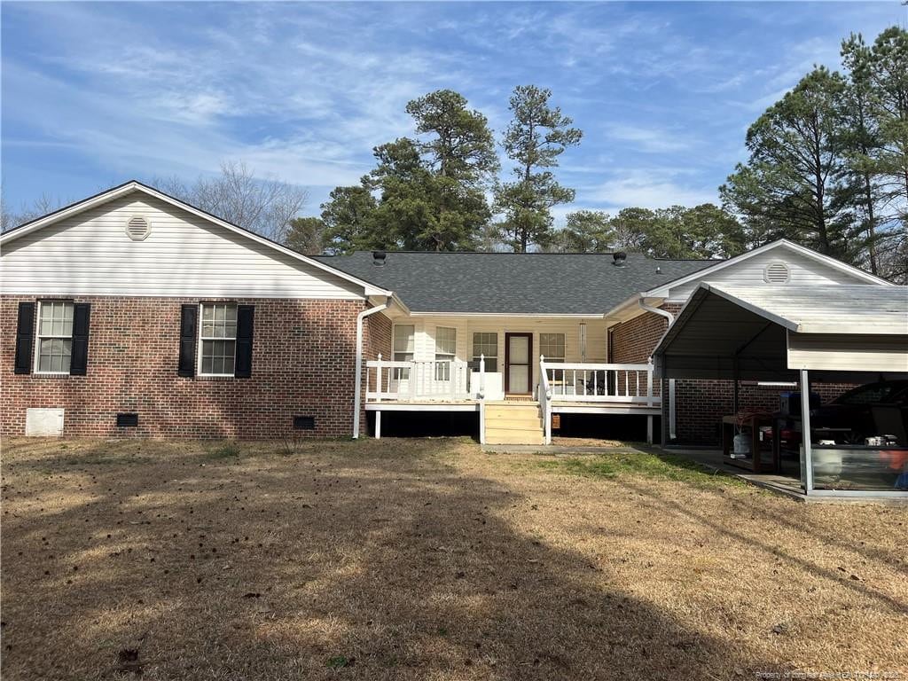 back of property featuring brick siding, crawl space, a shingled roof, and a wooden deck