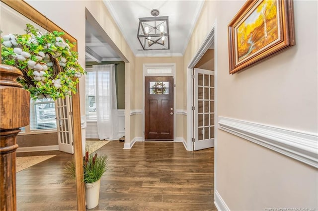 entrance foyer featuring crown molding, baseboards, and wood finished floors