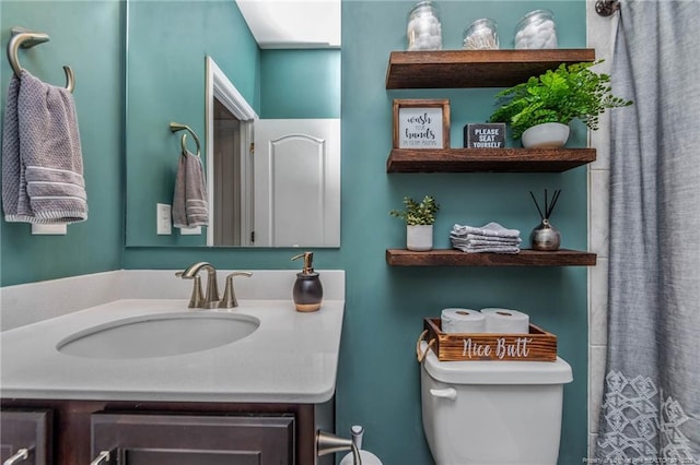 bathroom featuring vanity and toilet