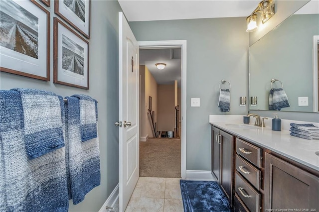 bathroom with baseboards, vanity, and tile patterned floors