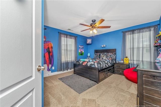 carpeted bedroom with ceiling fan and visible vents