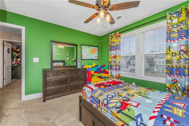 bedroom with carpet floors, ceiling fan, visible vents, and baseboards