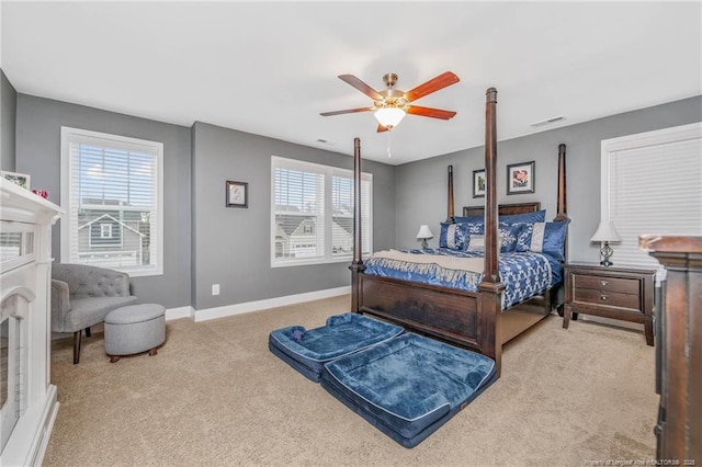 carpeted bedroom with baseboards, visible vents, and a ceiling fan