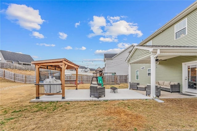 view of yard with a patio area, a fenced backyard, an outdoor living space, and a playground