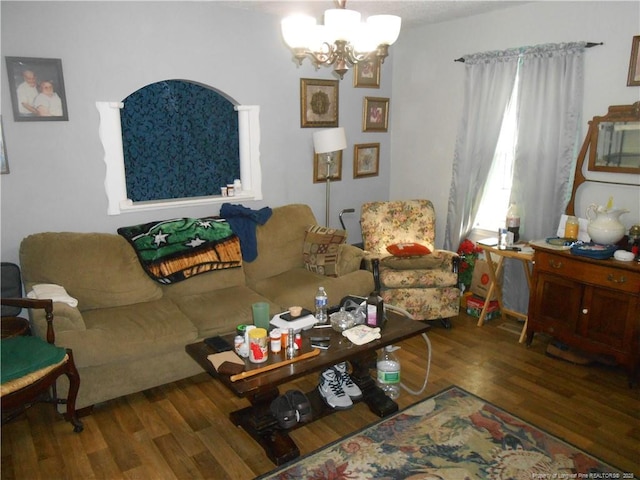 living room with a chandelier and wood finished floors