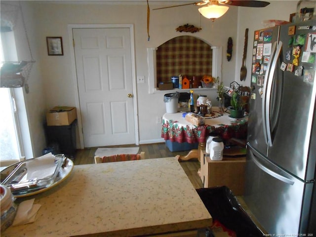 kitchen with light countertops, wood finished floors, freestanding refrigerator, and a ceiling fan