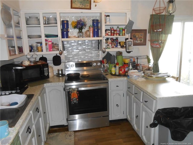 kitchen featuring dark wood-style floors, light countertops, white cabinets, a sink, and stainless steel range with electric stovetop