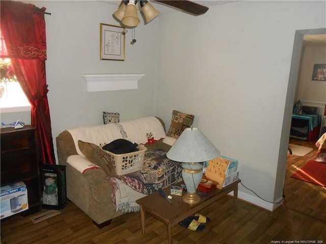 sitting room with ceiling fan, visible vents, and wood finished floors