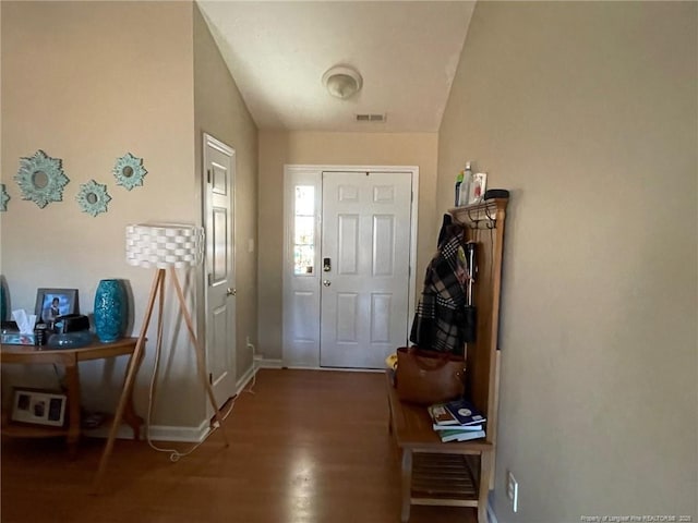 entrance foyer featuring visible vents, baseboards, and wood finished floors