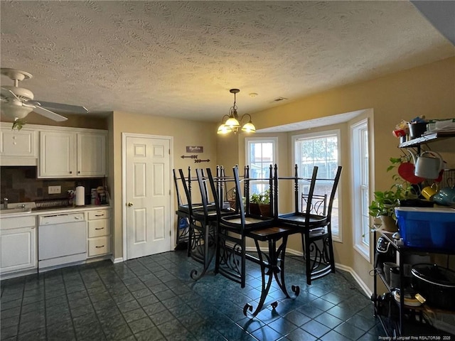 dining area with ceiling fan with notable chandelier and baseboards