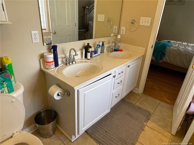 full bath with ensuite bathroom, a sink, and tile patterned floors