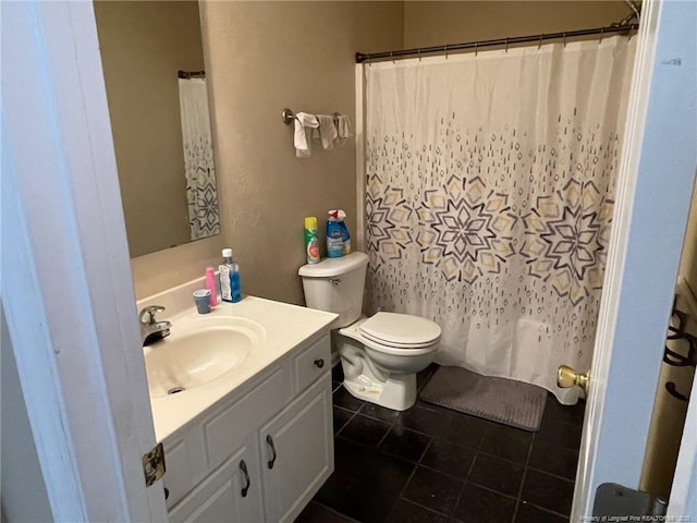 bathroom with curtained shower, vanity, toilet, and tile patterned floors