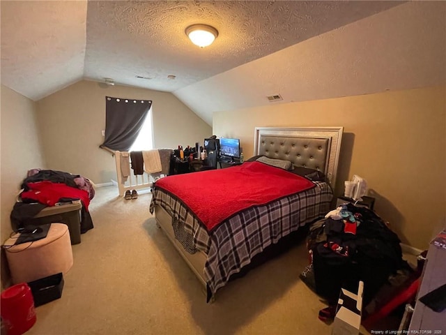 carpeted bedroom featuring a textured ceiling, lofted ceiling, visible vents, and baseboards