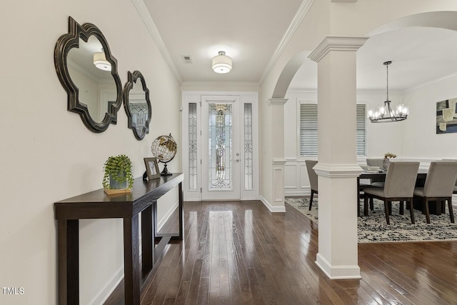 entryway with visible vents, dark wood finished floors, crown molding, and ornate columns