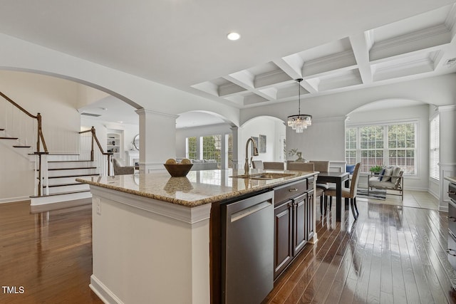 kitchen with a center island with sink, stainless steel dishwasher, open floor plan, and dark wood finished floors