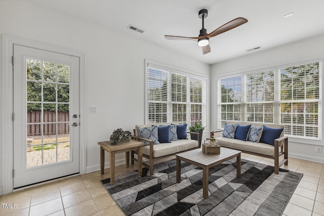 living area featuring visible vents, plenty of natural light, and light tile patterned flooring