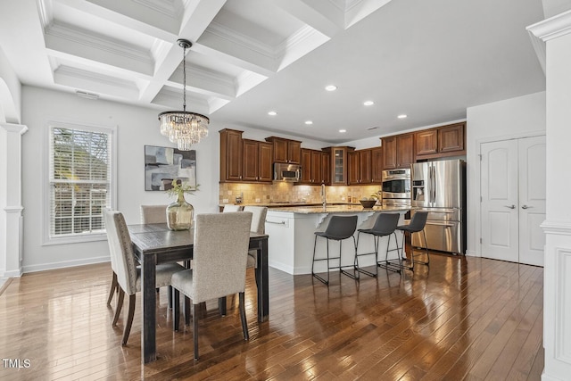 dining space featuring beamed ceiling, dark wood-style floors, and coffered ceiling