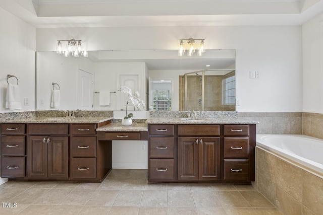 bathroom featuring tile patterned flooring, a garden tub, a stall shower, and a sink