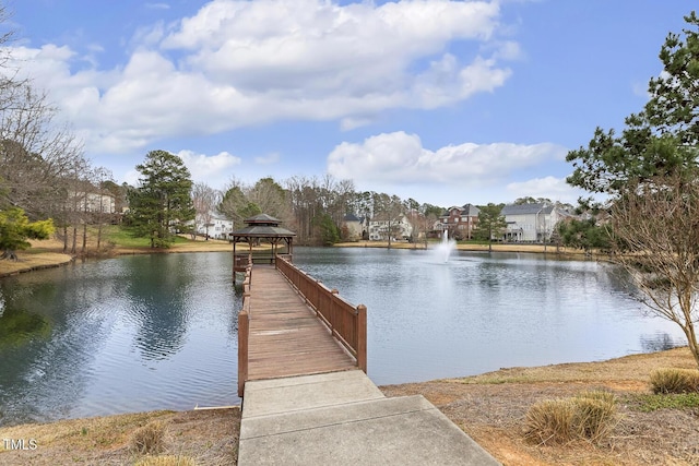 view of dock with a gazebo and a water view