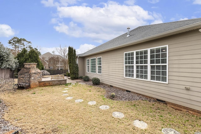 view of yard with a fireplace, a patio, and fence