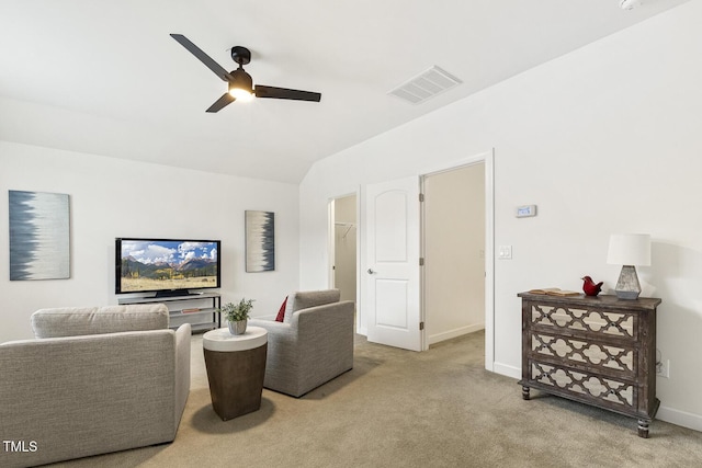 carpeted living area with lofted ceiling, a ceiling fan, visible vents, and baseboards