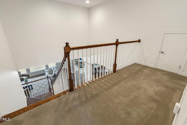 hallway featuring carpet flooring, an upstairs landing, recessed lighting, and baseboards