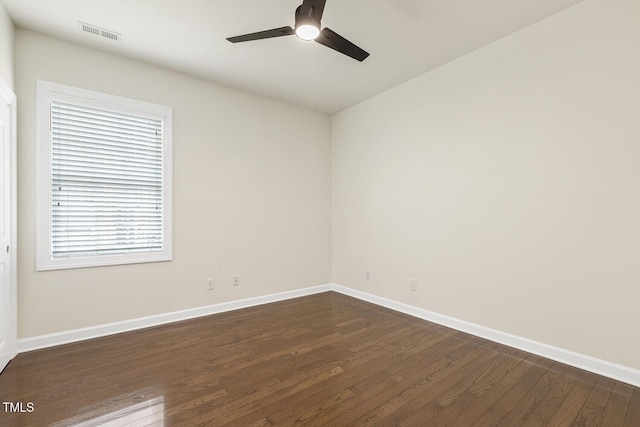 unfurnished room with visible vents, baseboards, a ceiling fan, and dark wood-style flooring