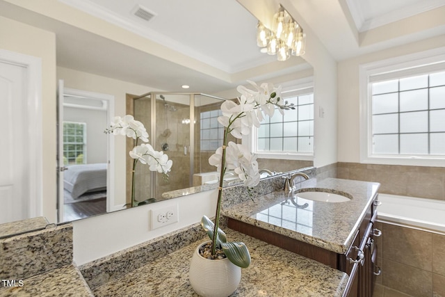 ensuite bathroom featuring vanity, visible vents, a stall shower, ornamental molding, and connected bathroom